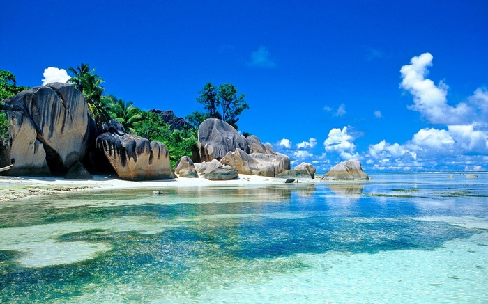 Tropical beach with granite boulders and clear turquoise water