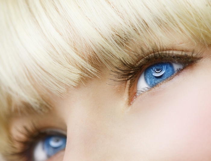 Close-up of a woman's blue eyes and blonde hair