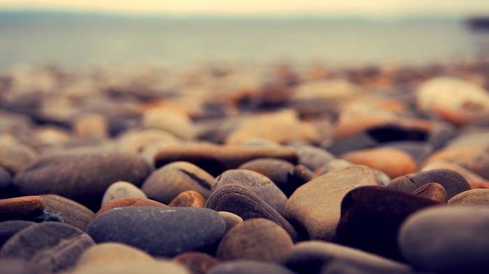 Close-up of smooth pebbles on a beach with shallow depth of field