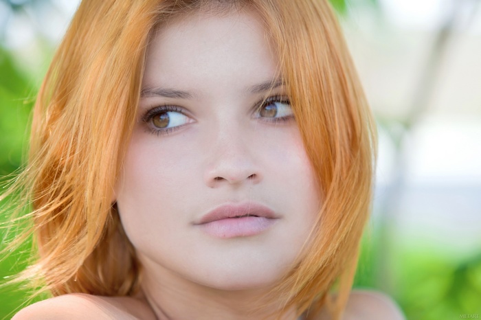 Young woman with red hair and brown eyes