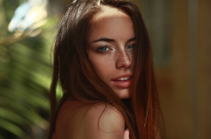 Portrait of a young woman with freckles