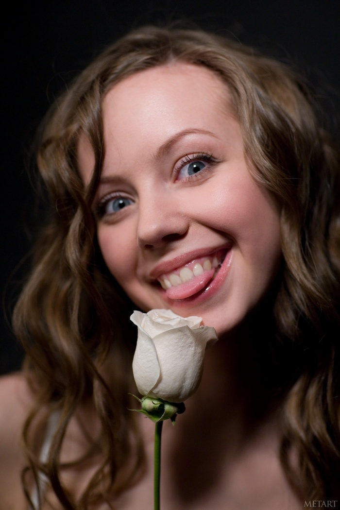 Natasha S. with a white rose and blue eyes