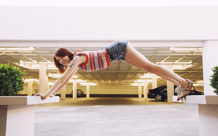 Bree Daniels in a plank pose on benches