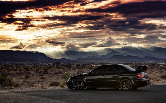 Black Subaru WRX STI with a large rear spoiler