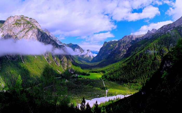 Mountains and valley with clouds and forest