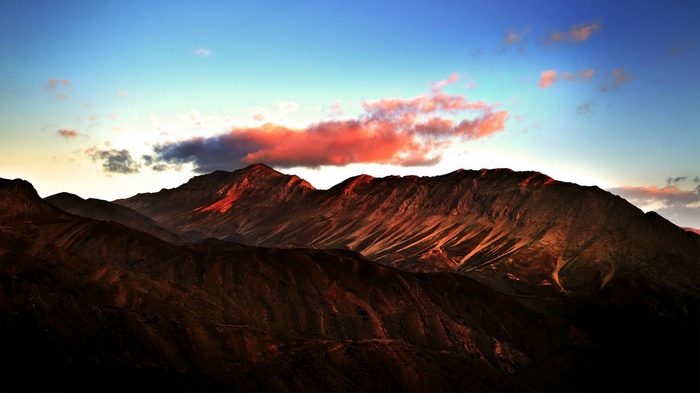 Mountains at sunrise with red clouds