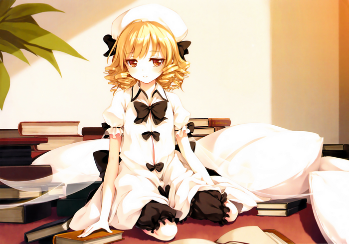 Luna Child sitting on books with pillows