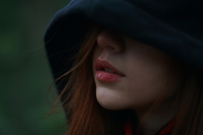 Woman with red hair wearing a hood