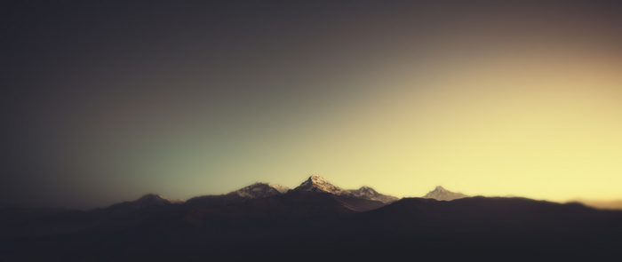 Snow-capped mountains at sunset