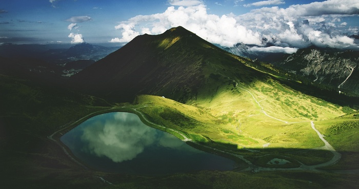 Mountain lake reflecting clouds and sky