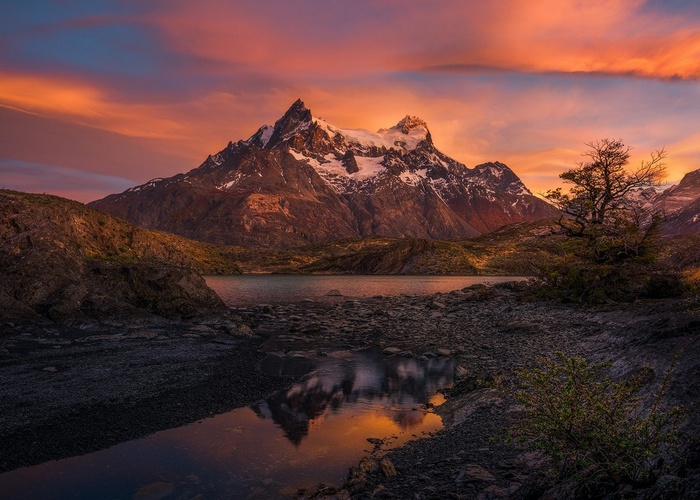 Torres del Paine mountains at sunrise with lake reflection