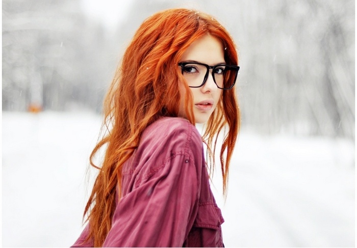 Redhead woman with glasses in the snow