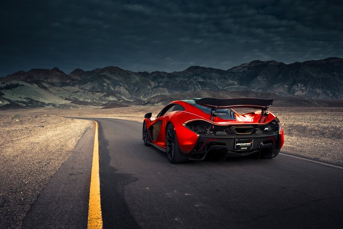 Red McLaren P1 on a desert road