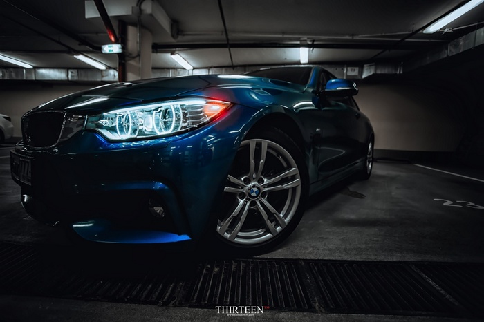 Blue BMW car parked in a garage