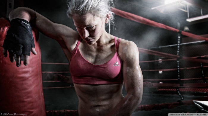 Woman in Adidas sports bra in boxing ring