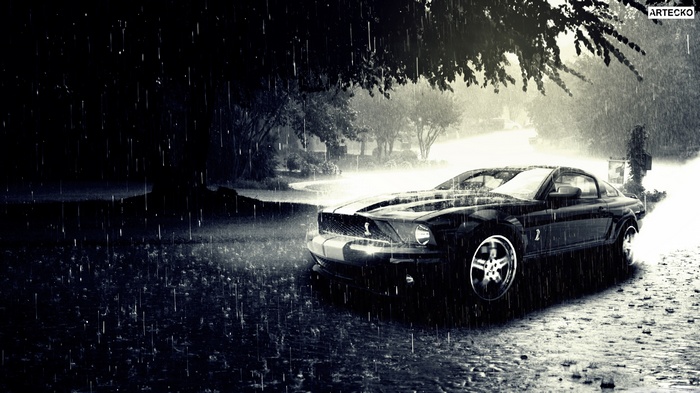 Black Ford Mustang in the rain