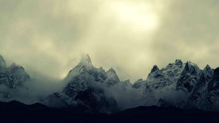 Snow-covered mountains shrouded in mist