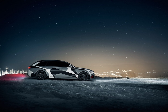 Audi RS6 Avant with camouflage wrap under starry sky