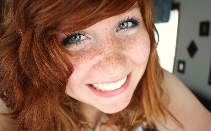 Redhead woman with freckles smiling