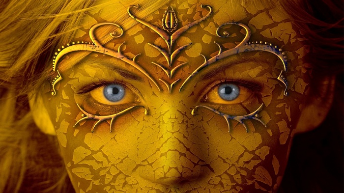 Woman with cracked golden face and blue eyes