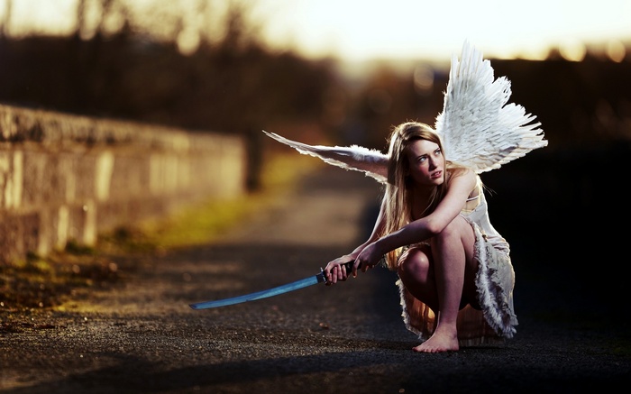 Woman with angel wings holding a sword