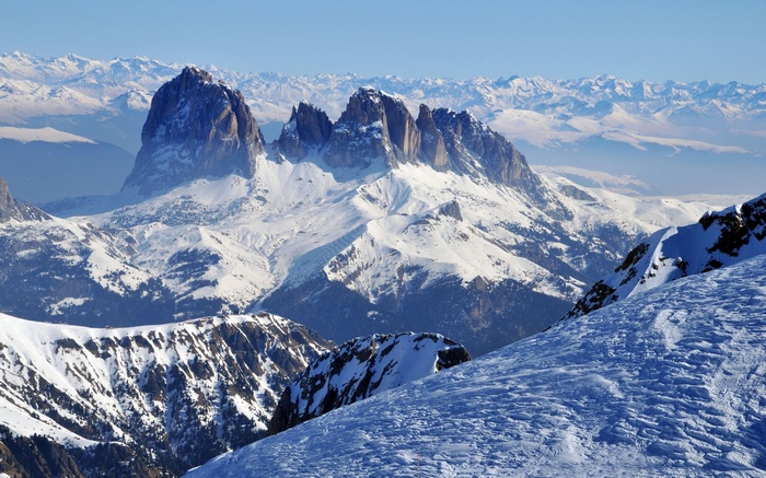 Snow-covered mountains under a clear blue sky