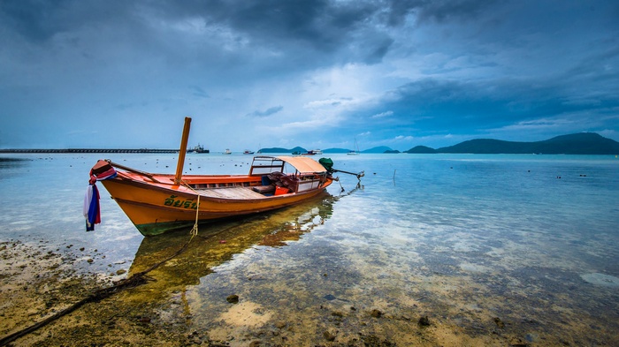 Orange boat on the shore in Thailand