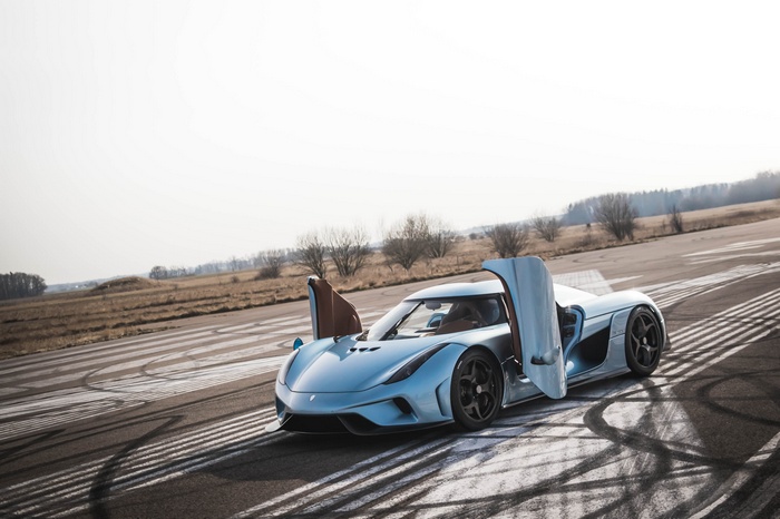 Koenigsegg Regera with doors open on a track