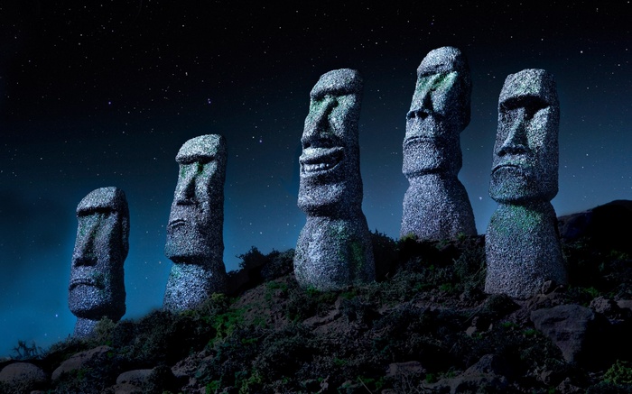 Moai statues under a starry night sky