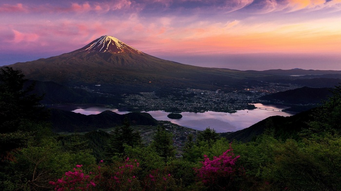 Mount Fuji at sunset with a lake and town