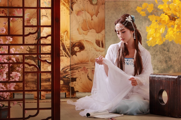 Asian woman in traditional white dress with headpiece