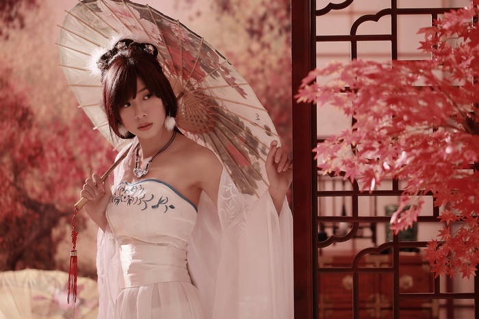 Asian woman in traditional dress holding an umbrella