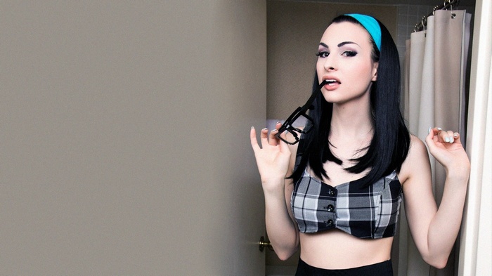 Bailey Jay with glasses and blue headband