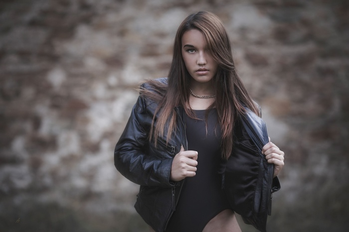 Woman in black leather jacket and monokini