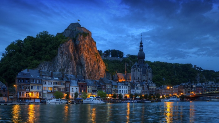 Dinant cityscape with citadel and church at dusk