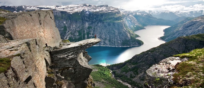 Man standing on Trolltunga rock in Norway