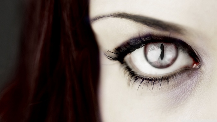 Close-up of a woman's eye with a cat-like pupil