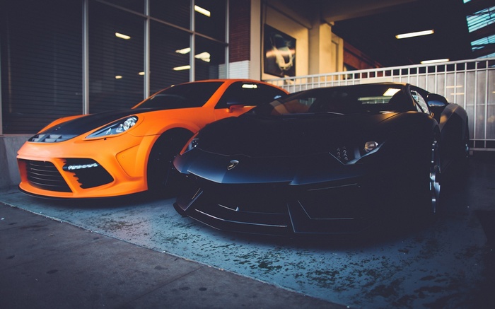 Black Lamborghini Aventador and orange Porsche Panamera