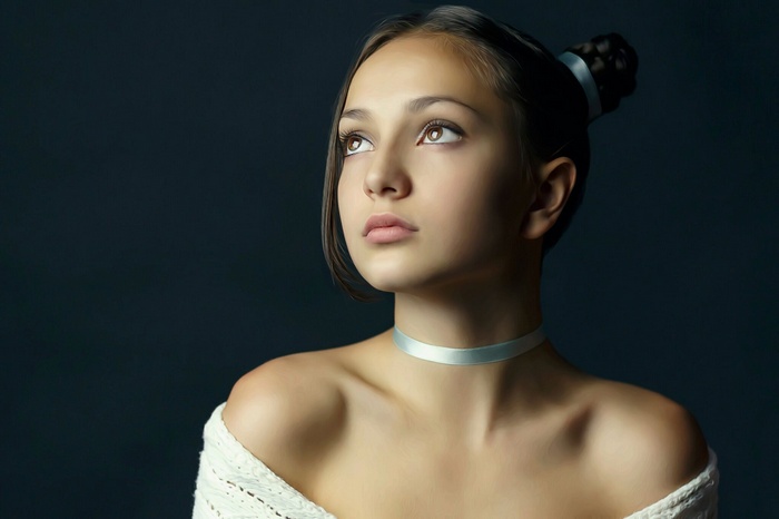 Young woman with dark hair and choker