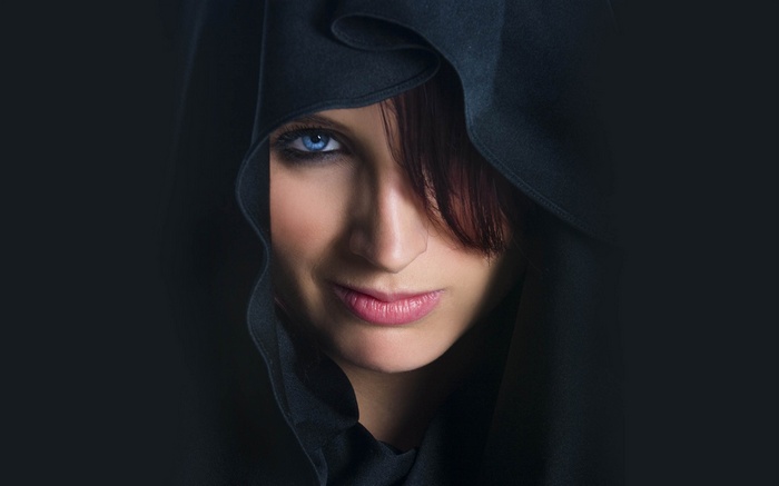 Woman with blue eyes and black hood