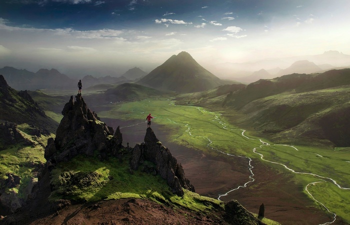 Two people slacklining between rocky peaks in Iceland
