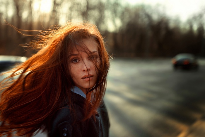Redhead woman with hair blowing in the wind