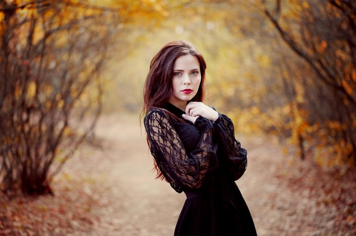Woman in black dress in autumn forest