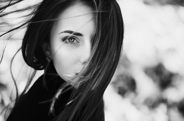 Monochrome portrait of a brunette woman with windblown hair