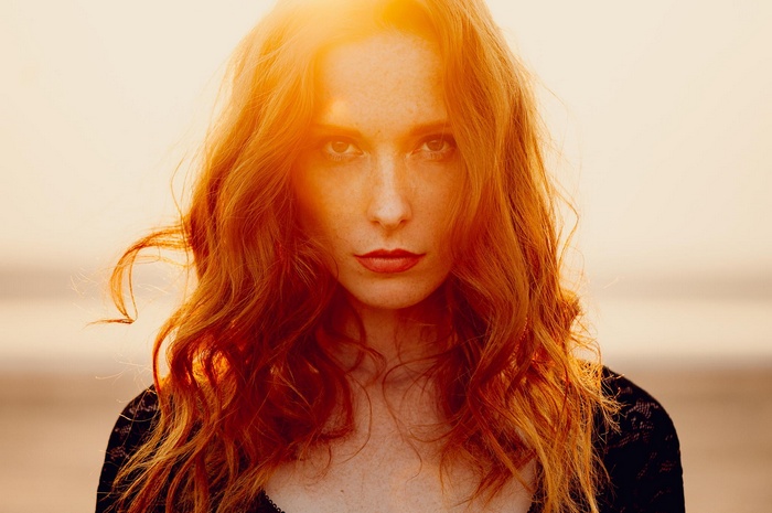 Ann Nevreva with red hair in sunlight