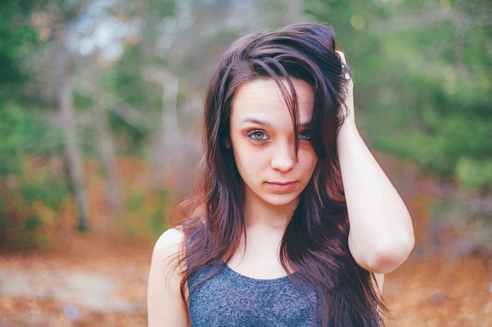 Woman with hand in hair outdoors