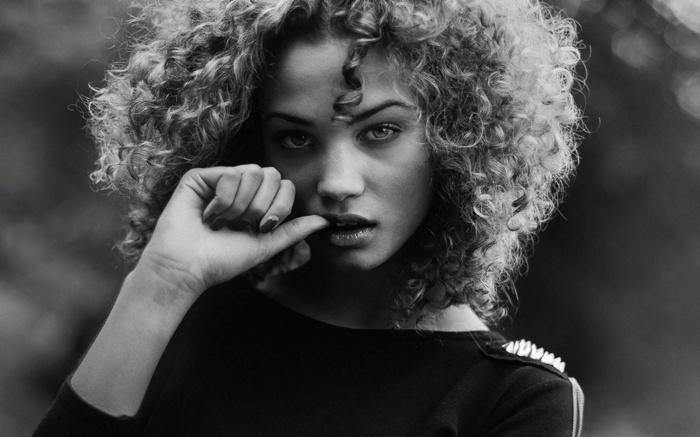 Rose Bertram with curly hair in black top