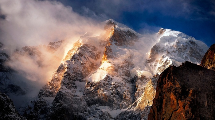 Snow-capped mountains shrouded in mist