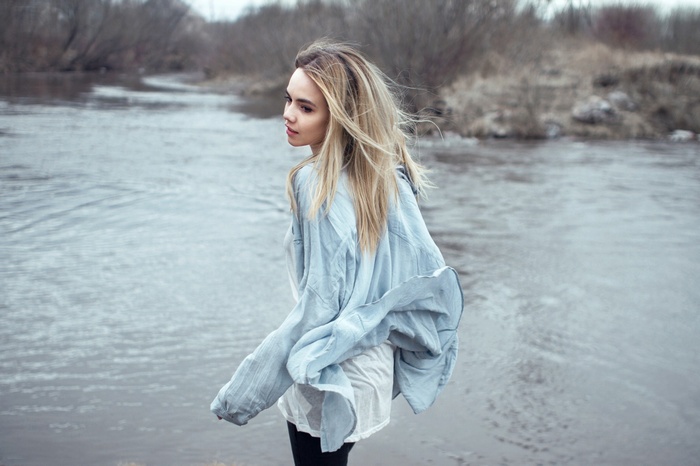 Woman with blonde hair by a river