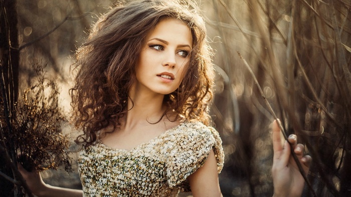 Ksenia Malinina in a field of dry grass